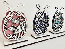 Load image into Gallery viewer, Easter decor with three cut out pattern designs. Display individually or all on one stand.
