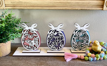 Load image into Gallery viewer, Easter decor with three cut out pattern designs. Display individually or all on one stand.