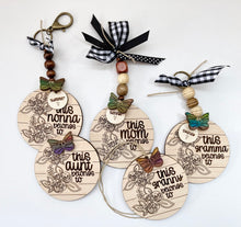Load image into Gallery viewer, Mom key rings with kids names and an added butterfly as an option.